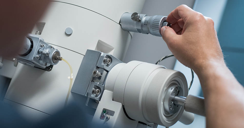 UBC Bioimaging Facility: hand adjusting a dial on large microscope